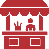 A red and white vector icon depicting a small market stall or vendor booth with a canopy, a person, and a hand gesture, set against a plain white background.