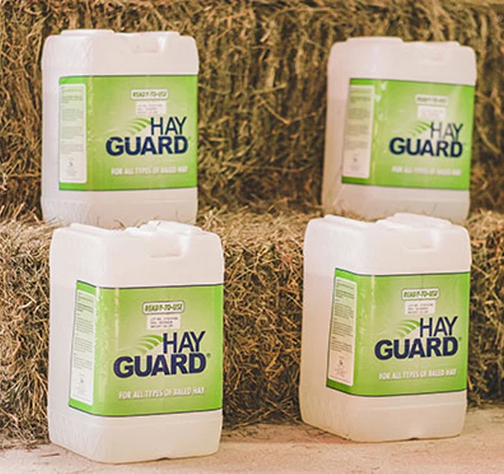 Hay Guard jugs stacked in front of hay bales