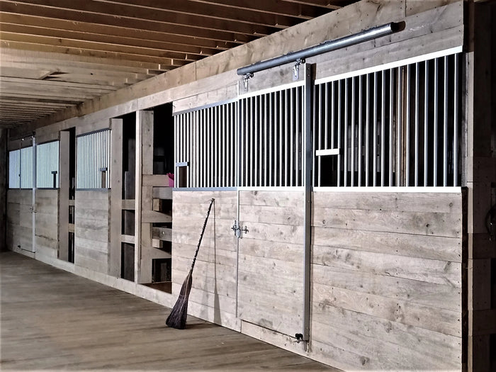 Aluminum horse stalls installed in barn aisle