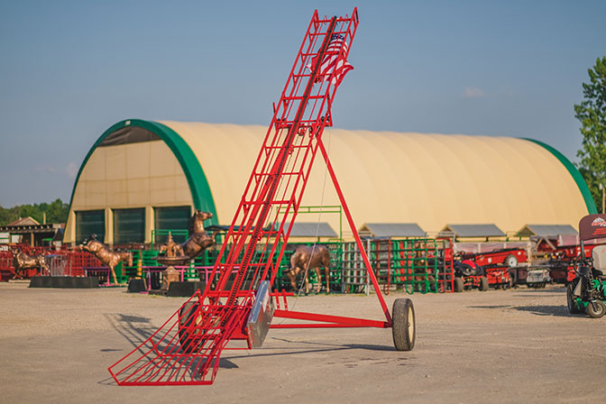 hay elevator with a bale chute on a transport kit. Essential equipment for horse farms